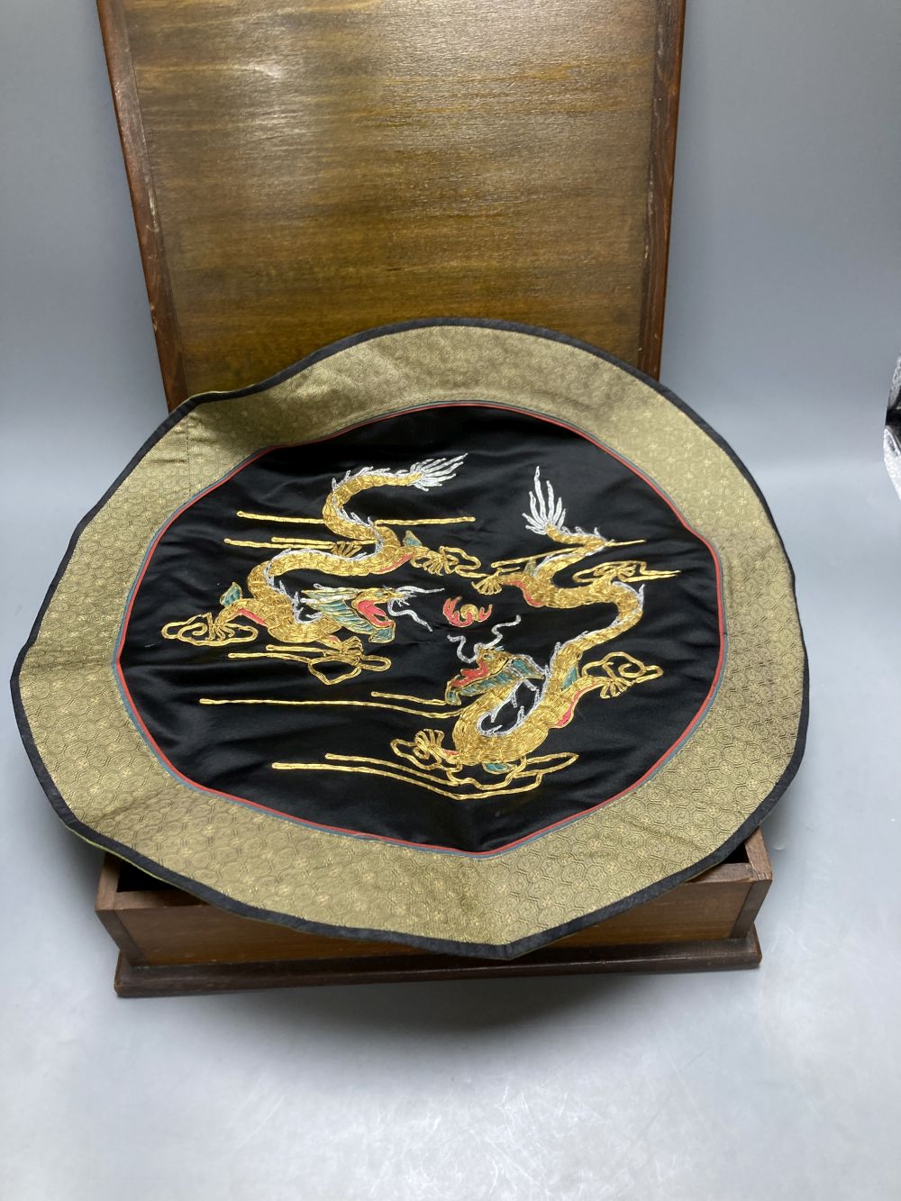 A Chinese circular silk roundel, 44cm and a Chinese kesi rank badge later attached to a box and a machine tapestry